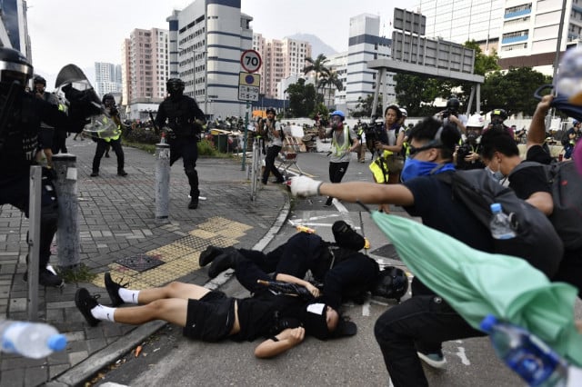 Hong Kong police fire tear gas as clashes return to city streets