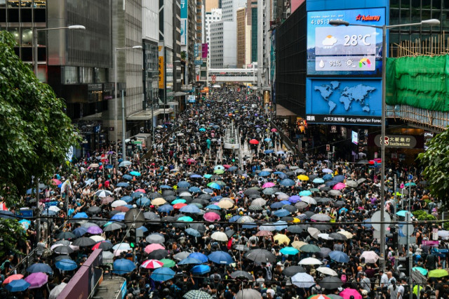  Flouting police ban, Hong Kong protesters flood city streets
