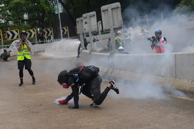 Police fire tear gas as large crowds defy Hong Kong mask ban