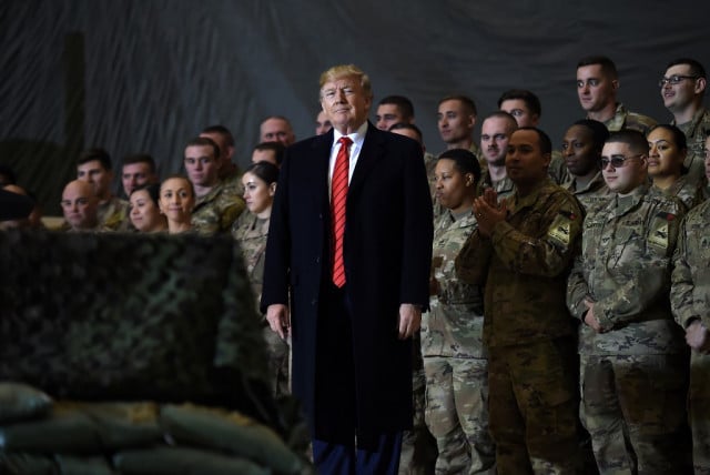 Trump visits troops in Afghanistan, says Taliban talks back on