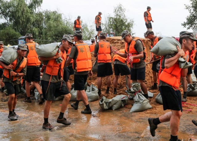 China rushes to contain floods after record rainfall