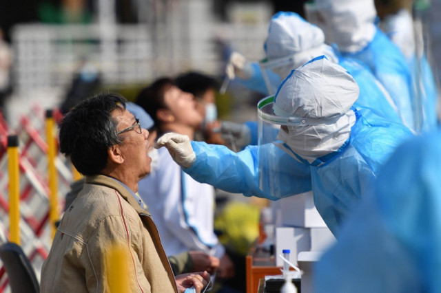 China to test whole city of 9m as Europe rolls out new virus rules