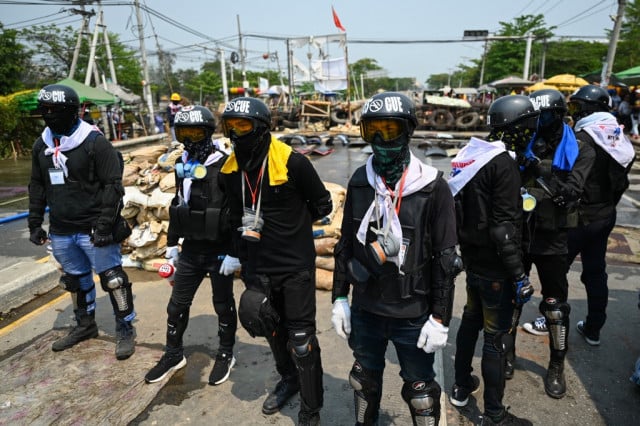 Three Myanmar protesters killed as hundreds defy junta curfew