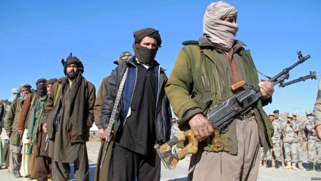 Taliban capture key border crossing as Biden defends Afghan withdrawal