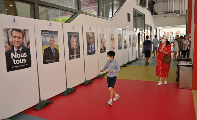  Voting starts as Macron seeks new term in tight French election