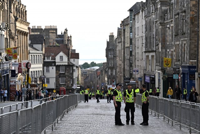 Queen's coffin heads to Scottish palace, historic church