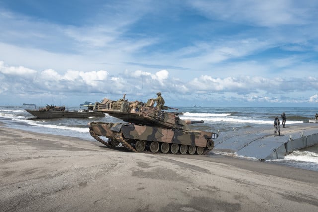 Australian, US, Filipino forces practice retaking an island in a drill along the South China Sea